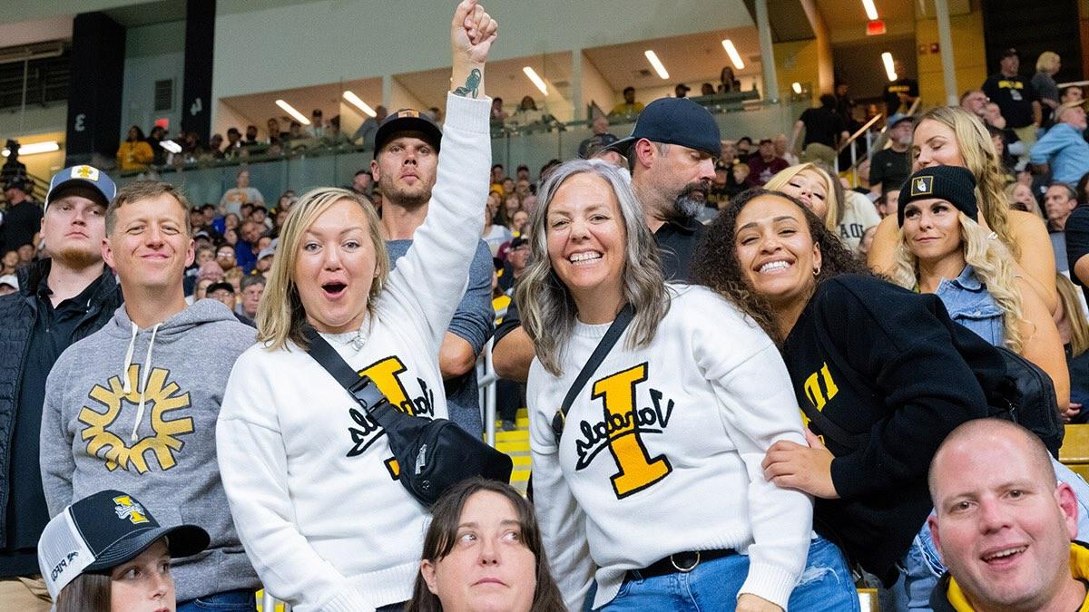 A group of students and fans at a Vandals football game cheering